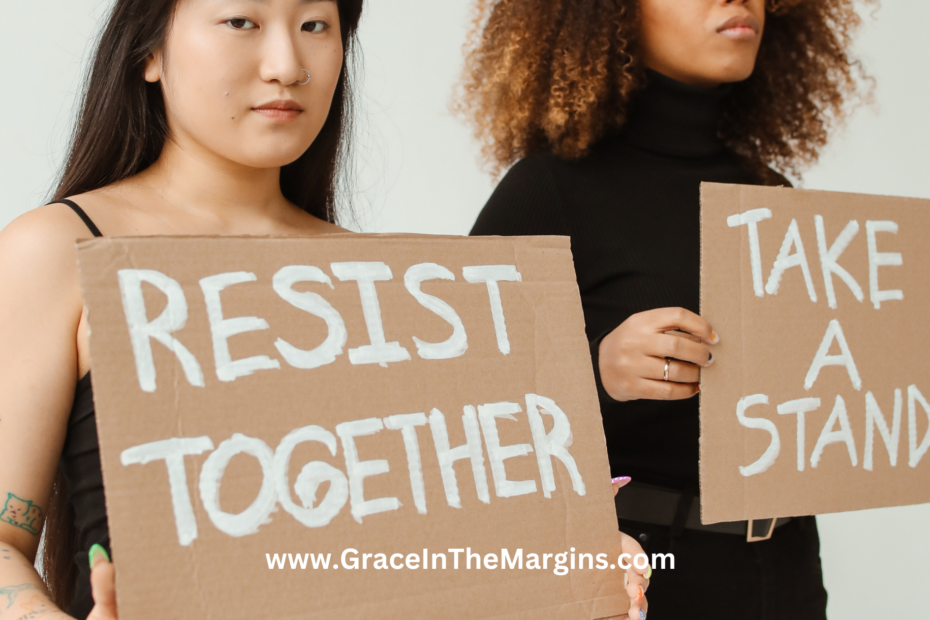 Fear vs anger. Two women holding up cardboard signs that say resist together and take a stand.